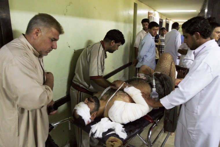 Medics evaluate a patient at an emergency room in the Shiite enclave of Sadr City after he was injured in a minibus bombing in east Baghdad, Iraq, on Saturday.