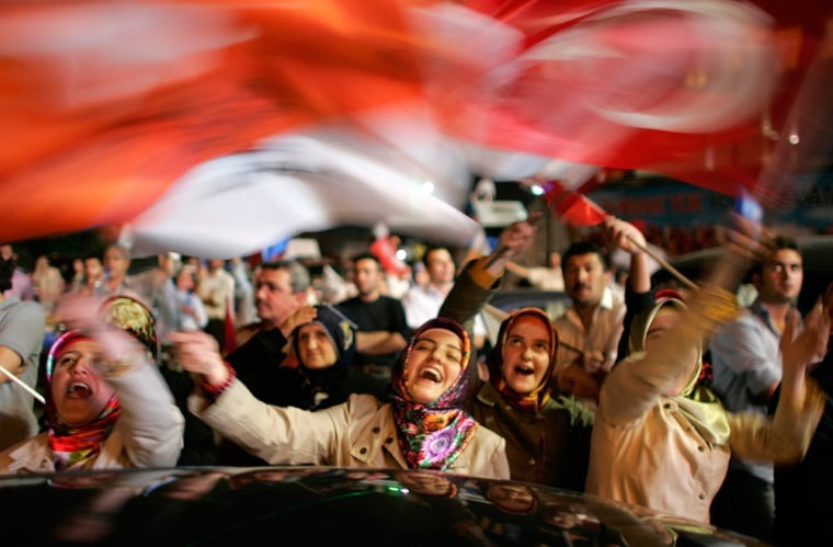 Turkey's ruling AK Party supporters celebrate results of the national elections in front of the party headquarters in Ankara