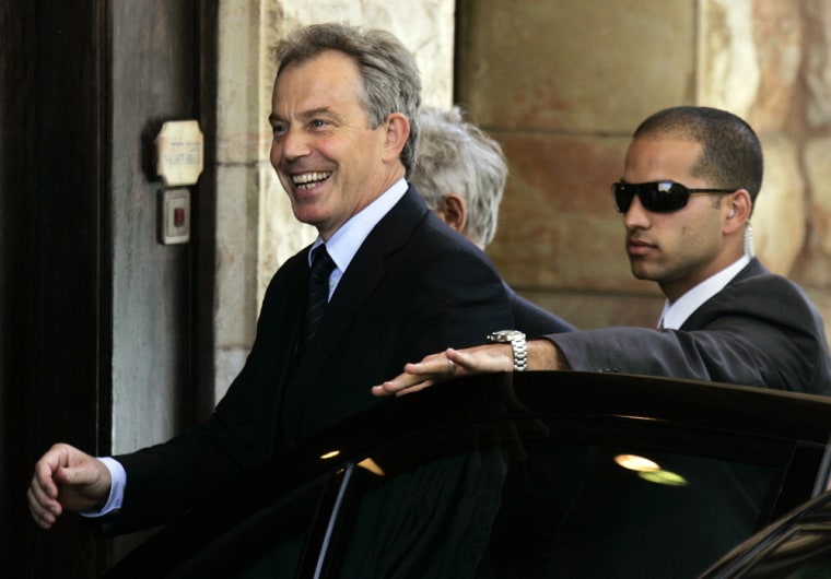 Former British Prime Minister Tony Blair, the new Middle East peace envoy, smiles as he arrives at the King David Hotel in Jerusalem on Monday. 
