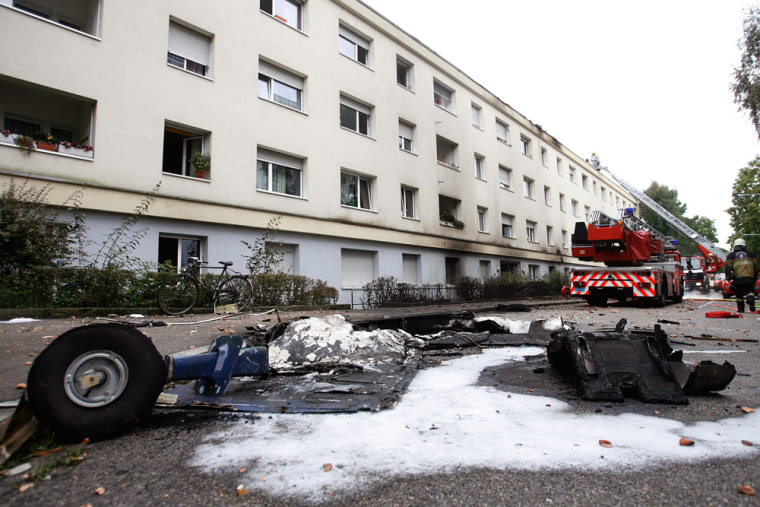 Plane wreckage is pictured in front of a building following an accident involving a small plane in a residential area in Basel