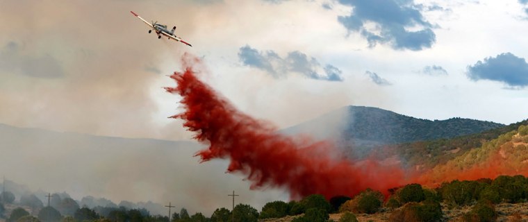 An air tanker drops retardant on the Salt Creek fire in Big Hallow Canyon outside Fountain Green, Utah Monday, July 23, 2007.  The Salt Creek fire has grown to over 18,000 acres and is still threatening several communities in the area.  (AP Photo/George Frey)