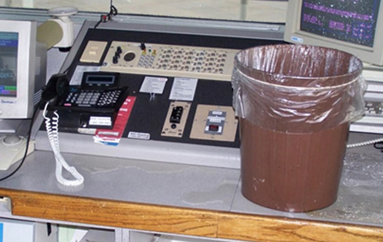 A wastebasket sits on a console to catch water falling through a leak in the roof of the tower cab in the air traffic control tower at Gerald R. Ford International Airport in Grand Rapids, Mich. Seventy-five airport towers reported water leaks, including six with frequent leaks directly over controllers or equipment. 