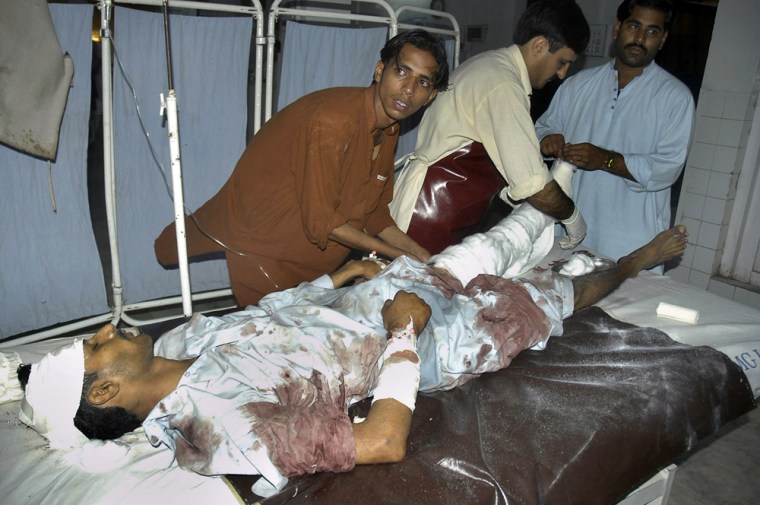 Pakistani paramedical staff give initial treatment to an injured victim of a rocket attack in Bannu, at a local hospital in Peshawar, Pakistan on Wednesday. Assailants fired four rockets into Bannu, a city in northwestern Pakistan before dawn on Wednesday.
