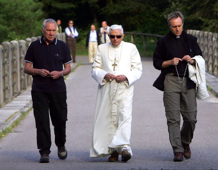 Pope Benedict XVI, wearing sun glasses, and his personal secretary Georg Gaenswein, right, and his personal assistant Angelo Gugel, left, walk on a bridge of the Centro Cadore's lake in Domegge, Lorenzago di Cadore, near Belluno, Italy, Monday, July 23. 