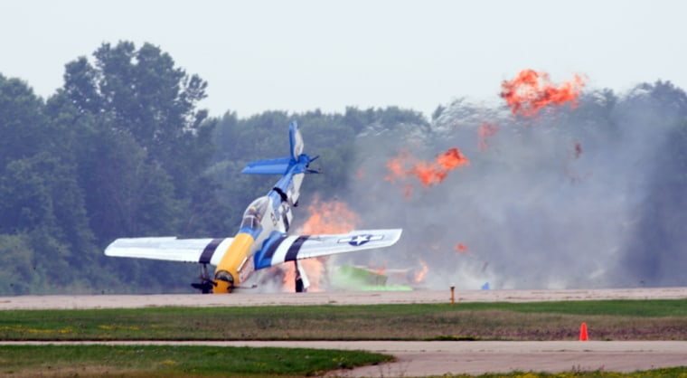 A vintage P-51 Mustang smashes into the ground at the Experimental Aircraft Association's annual AirVenture show in Oshkosh, Wis., on Friday after colliding with another WWII-era fighter. 