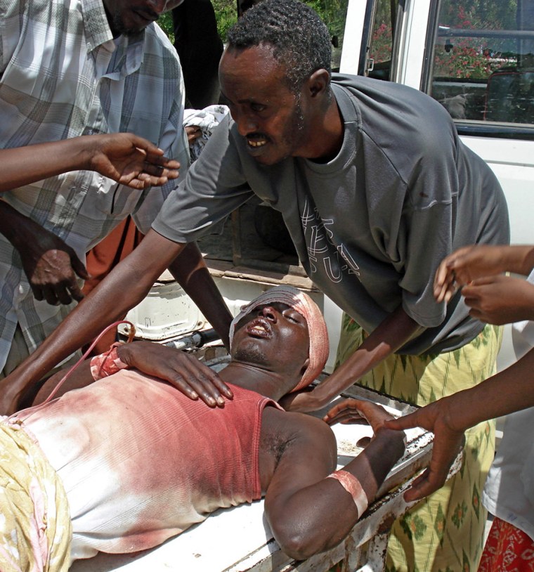 A wounded man is wheeled to a hospital in Mogadishu, Somalia, on Sunday following an explosion at a market. A spate of gunbattles and grenade attacks killed two soldiers and two civilians in the capital, where the government is struggling to contain a violent insurgency.