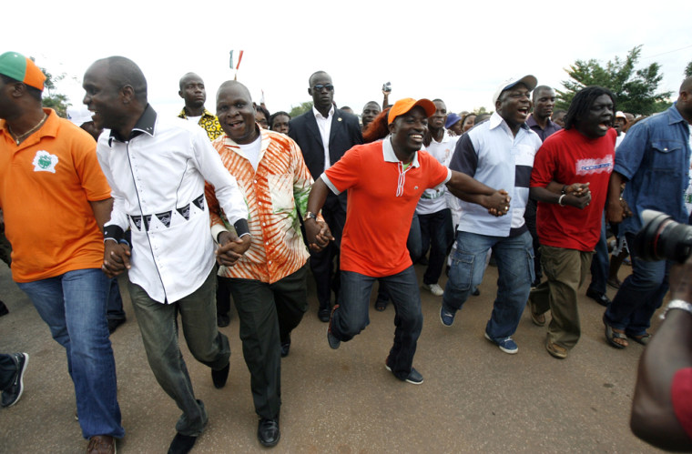 Charles Ble Goude, leader of Ivory Coast's Young Patriots, dances as he arrives with his delegation in Bouake