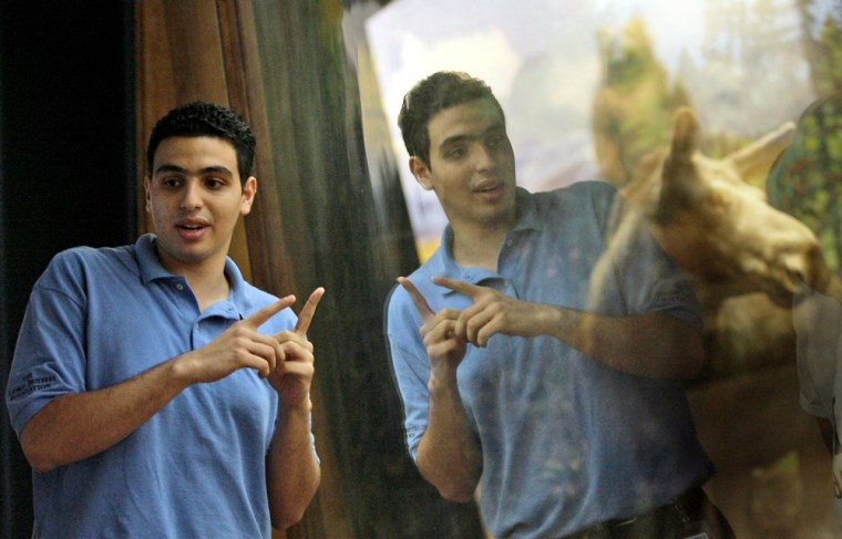 Hassan Mohamed, 19, talks about a moose's horns during his \"Attack and Defense\" tour for students of P168 from the Bronx borough Tuesday, July 24, 2007 in at the American Museum of Natural History in New York. For the 12th year, the museum is allowing college students to design their own excursions as guides through the vast institution as guides, and to use their enthusiasm to capture the interest of even younger minds. (AP Photo/Mary Altaffer)