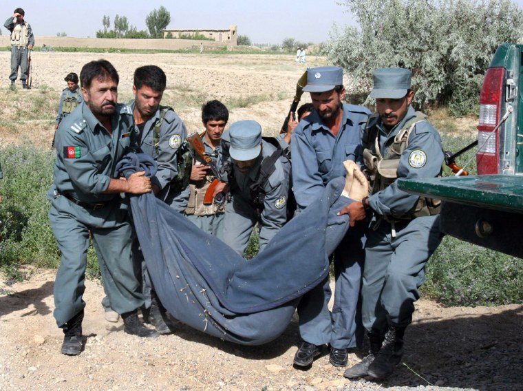 The body of Shim Sung-min, 29, one of the South Korean hostages is carried by policemen after he was killed by the Taliban militants in Ghazni province, west of Kabul, Afghanistan on Tuesday, July 31, 2007. Police in central Afghanistan at daybreak Tuesday discovered the body of a second South Korean hostage slain by the Taliban, officials said.