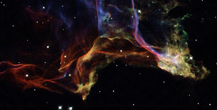 The image displays two characteristic features of the Veil Nebula: sharp filaments and diffuse patches, which correspond to viewing the supernova remnants from edge-on and face-on views, respectively. 
