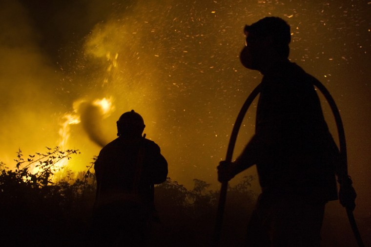 Firefighters work at the scene of the fire on Tenerife, one of the Canary Islands, on Wednesday.