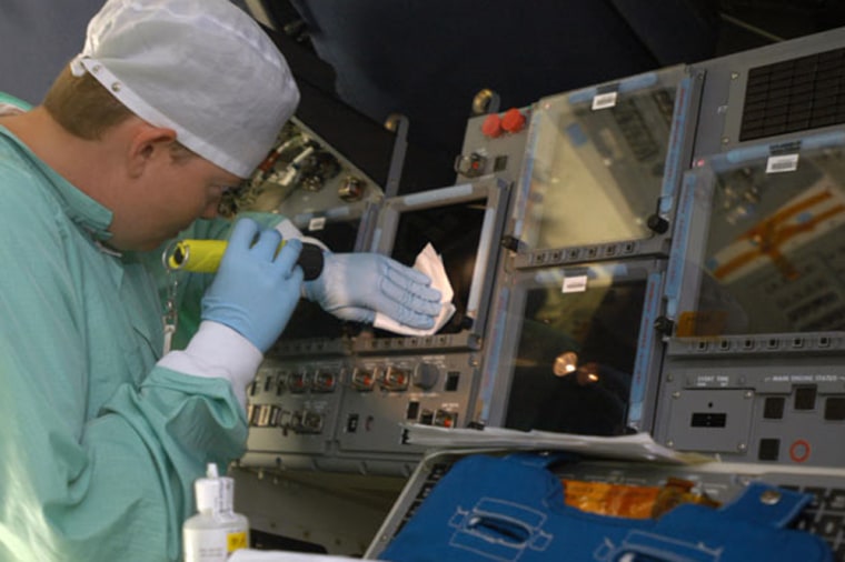 Carmen Prater, with United Space Alliance, cleans a screen on the flight deck of the orbiter Endeavour in bay 2 of the Orbiter Processing Facility during a major overhaul that saw the installation of the Multifunction Electronic Display Subsystem - a state-of-the-art 'glass cockpit.'