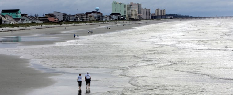 Beachcombers look for treasures Friday, Sept. 1, 2006, a day after Tropical Storm Ernesto passed through Cherry Grove, S.C. Heavy rains brought flooding in some areas of North Myrtle Beach.(AP Photo/Mary Ann Chastain)