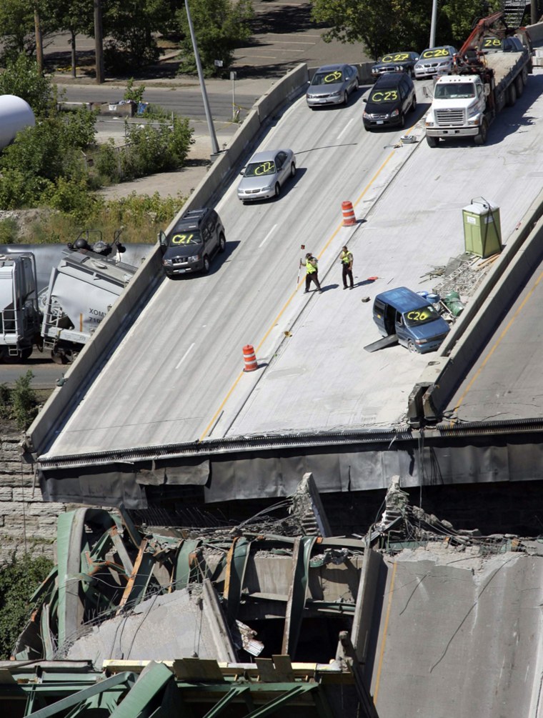 Emergency personnel survey the remains of the I-35W bridge in Minneapolis