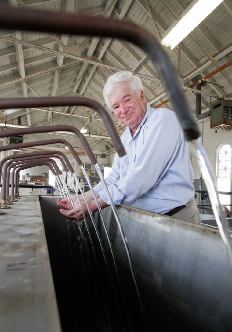 Marvin Russell, water purification superintendent for New Orleans, poses for a picture with pure water during a tour of the water treatment facility in New Orleans Monday, July 9, 2007. The city Sewerage & Water Board says at least 50 million gallons of water a day are now being lost to leaks, or 2 times pre-Katrina levels. S&WB officials also believe raw sewage is spilling into the ground, though the extent of the problem is unclear. (AP Photo/Alex Brandon)