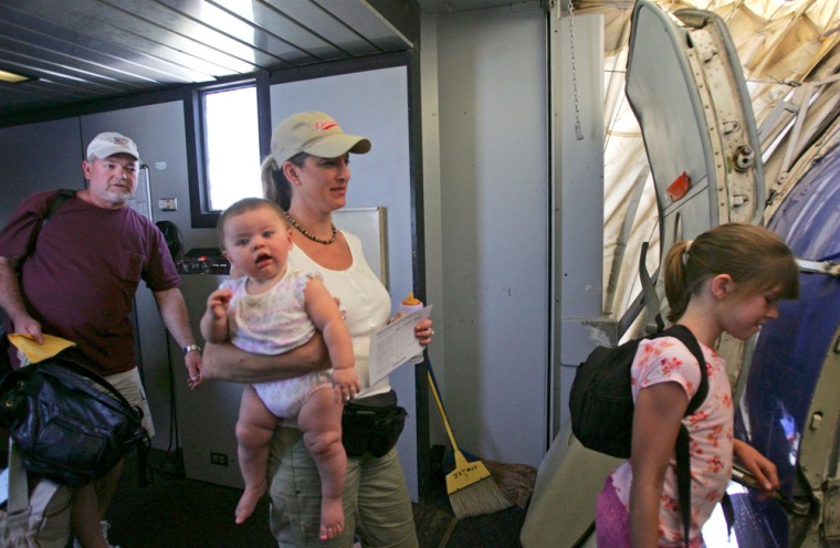 The Flanagan family boards a flight during the designated family boarding time in San Antonio, where Southwest airlines has been testing new boarding procedures.