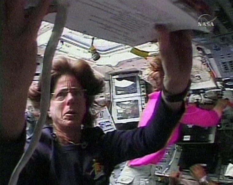 Educator-astronaut Barbara Morgan studies a checklist in the shuttle Endeavour's cockpit on Thursday.