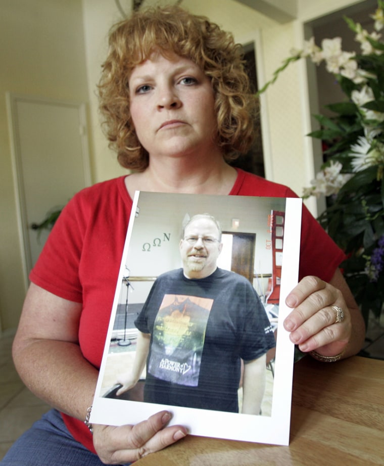 Kathleen Wright holds an image of her brother, Cecil Sinclair, who recently passed away, on Friday, Aug. 10. Relatives of Sinclair, a gay Navy veteran, say they are upset that a megachurch canceled his memorial service 24 hours before it was to start. 