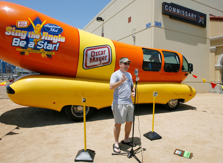 A Wienermobile much like this one was ticketed Thursday in Chicago. The vehicle in the photo is parked, presumably legally, at Naval Station San Diego, with Petty Officer Steve Dotson in front of it singing the "Oscar Mayer Wiener Jingle." It's no "Anchors Aweigh," but there was a contest.