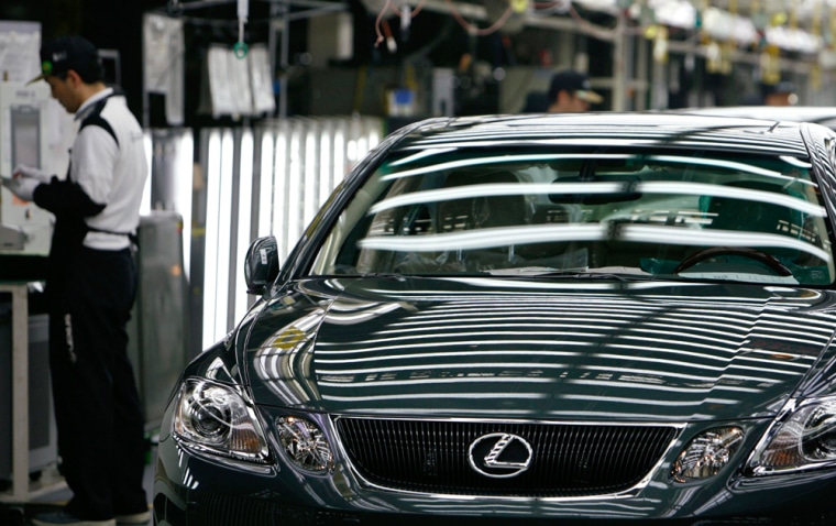 Employees of Toyota Motor Corp. work on assembly line producing Lexus vehicles at Tahara plant in Tahara, central Japan