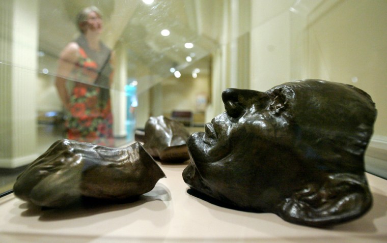 Bronze pieces made from the original casts of Abraham Lincoln's hands and face in 1860 are seen Monday, Aug. 13, 2007, at the Chicago History Museum. The facial cast is one of two life masks used in a new study that found an unusual degree of asymmetry in the 16th president's face. (AP Photo/M. Spencer Green)