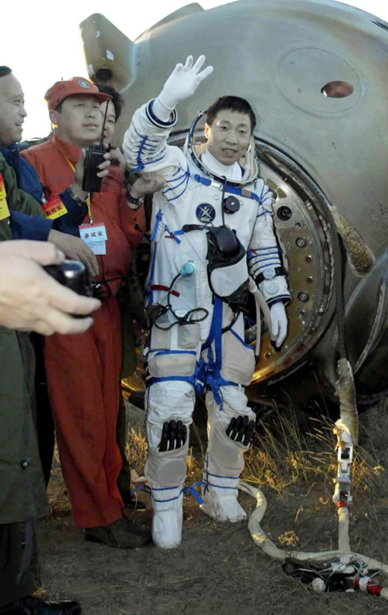First Chinese astronaut Yang Liwei waves after landing on the Inner Mongolian grasslands of northern China Thursday, Oct. 16, 2003 after 21 hours in orbit.