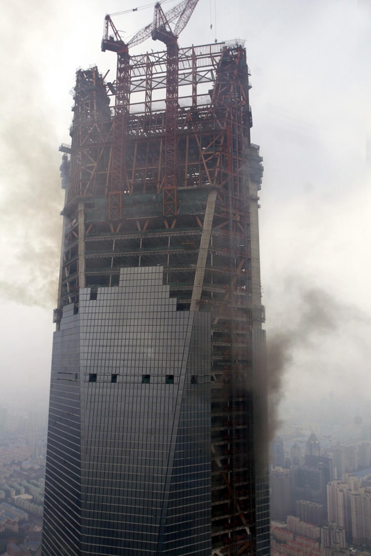 Smoke rises from the Shanghai World Financial Centre in Shanghai