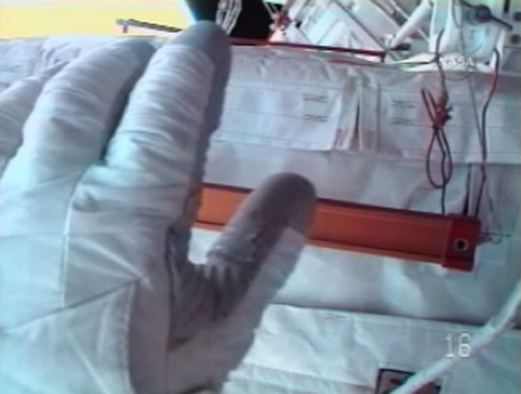 This photo from spacewalker Richard Mastracchio's helmet-cam shows his left glove, with a cut visible on the thumb. The damage led to the early termination of Wednesday's spacewalk at the international space station.