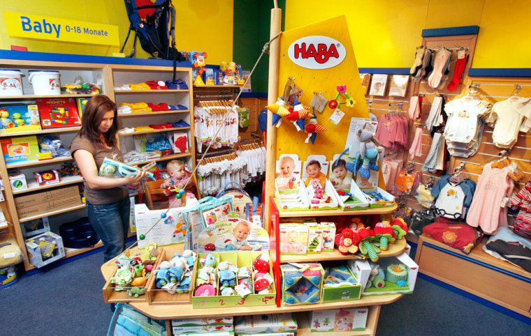 Karina Schelhorn looks for toys for her daughter Karina in the HABA (Habermass GmbH) company in Bad Rodach, Germany, Tuesday Aug. 14, 2007. With about 80 percent of all toys sold in the U.S. made in China, German toy maker Haba knows it supplies a very small niche market. But since the worldwide recall of more than 18 million Chinese-made toys tainted with lead-laced paint, smaller European toys makers that stress natural and safe materials in their cars, building blocks and trains, are seemingly well-positioned to attract attention from concerned parents now more willing to pay more for their child's playthings. (AP Photo/Jens Meyer)
