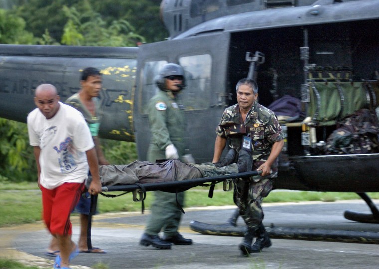 A body of a soldier is unloaded from a helicopter upon its arrival at a military base in the southern Philippine city of Zamboanga on Saturday.
