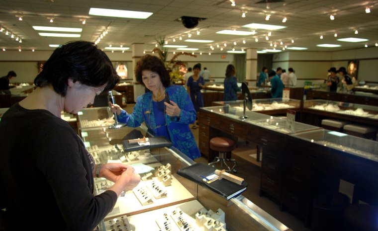 Shoppers browse in the main showroom at Maui Diver Jewelry Design Center in Honolulu, Hawaii. In 50 years of business, the company has grown into the world's largest manufacturer of black coral jewelry and Hawaii's largest jewelry retailer.