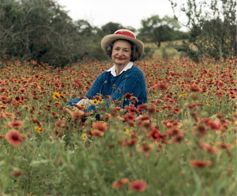 File photo of former U.S. First lady Lady Bird Johnson posing in a field of willdflowers in Texas