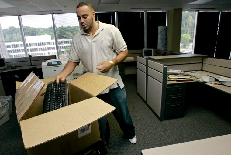 Archie Clark packs computer equipment at a recently closed HomeBanc Corp. office in Raleigh, N.C. this week. He is one of more than 23,000 workers who have lost jobs in financial services industry this month.