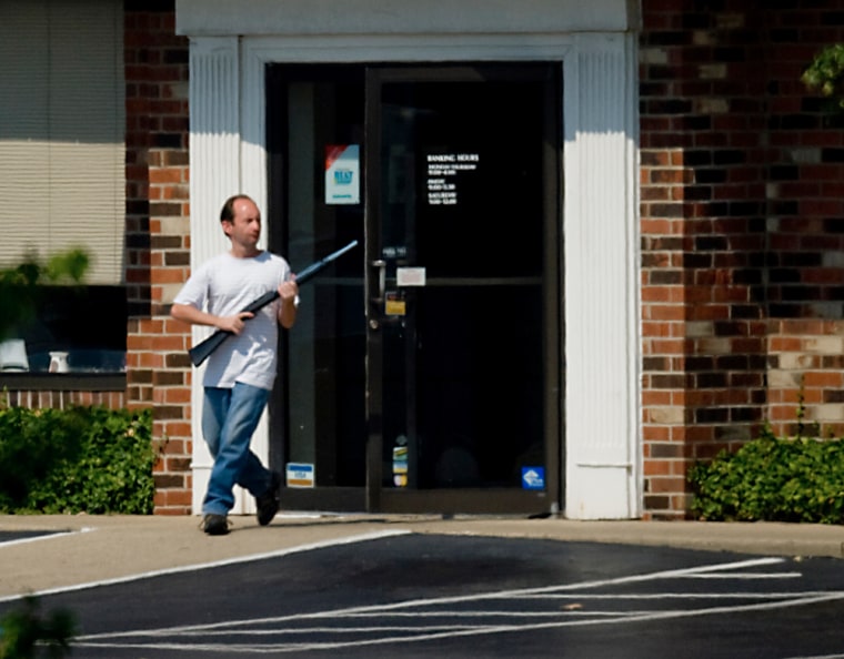 An armed man, pictured exiting a Ky. National City Bank branch Monday, briefly held four bank employees hostage.