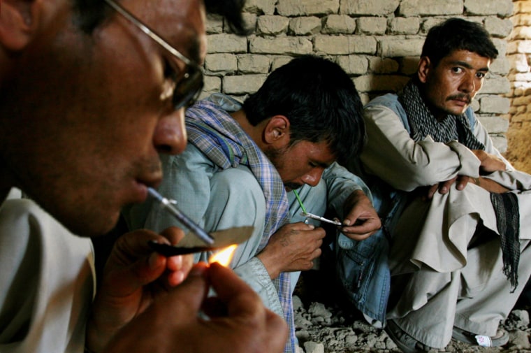 Afghan men smoke heroin on Monday. Afghanistan produced 93 percent of the world’s opium in 2007, the annual UNODC report said.