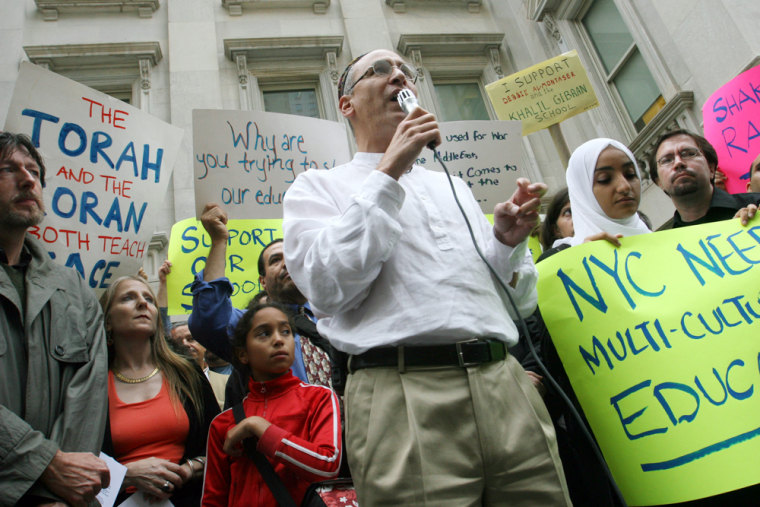 Rabbi Michael Feinberg, executive director of the Greater New York Labor-Religion Coalition, center, speaks Aug. 20 during a demonstration in support of the Khalil Gibran International Academy in New York.