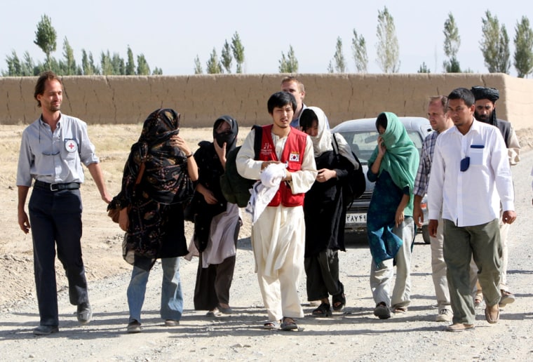 Another five released South Korean hostages are seen walking after they were released by Taliban militants in Ghazni province, west of Kabul, Afghanistan on Wednesday, Aug. 29, 2007. Taliban militants released eight South Korean hostages on Wednesday, the first of 19 captives scheduled to be freed under a deal struck between the insurgents and the South Korean government. (AP Photo/Musadeq Sadeq)