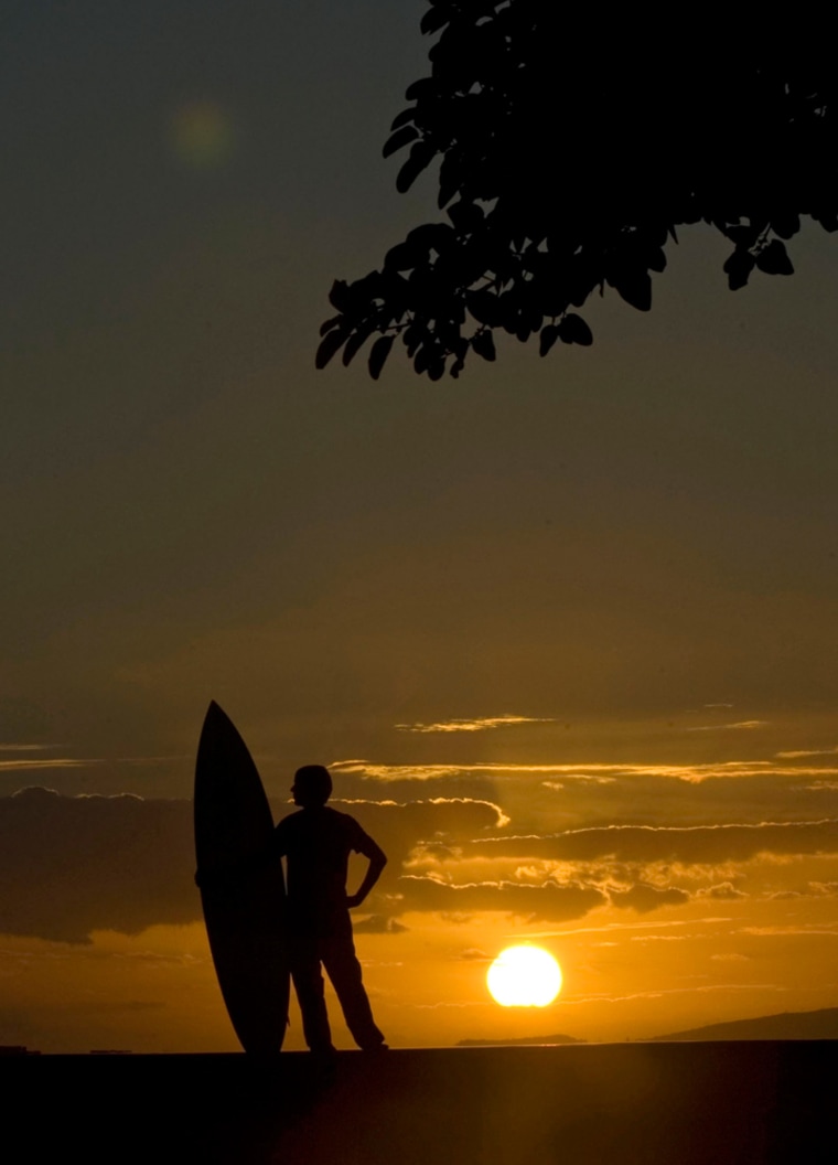 Steve Boco of Kailua, Hawaii, looks out over the pacific ocean at sunset at Ala Moana Beach Park in Honolulu