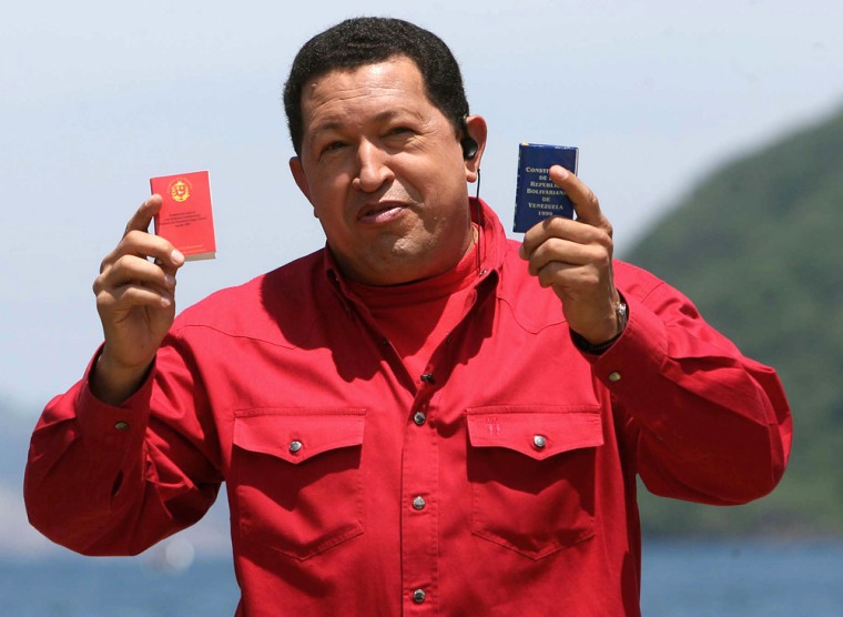 Venezuelan President Hugo Chavez shows, during his TV program "Alo Presidente" on Aug. 27, the two versions of the Venezuelan Constitution, the present one, in blue, passed in 1999, and the new one, in red, to be approved by Congress and through a referendum.