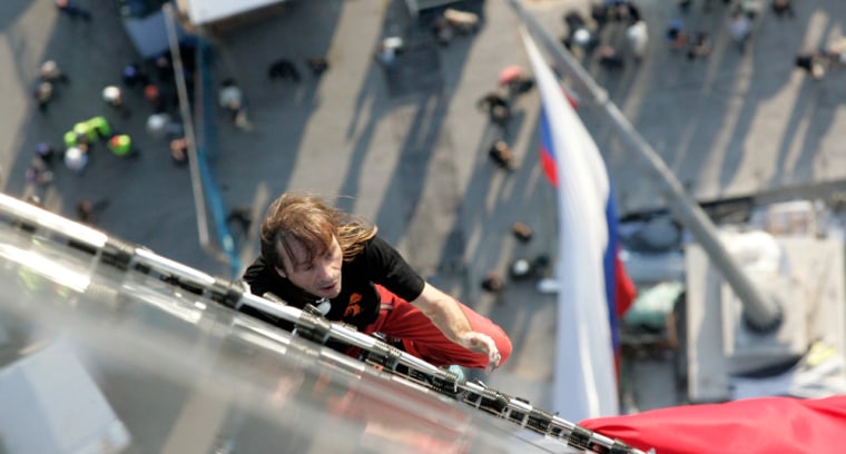 French extreme climber Alain Robert climbs a building in Moscow
