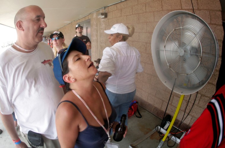 Kat and Joe Santos seek relief from the 102-degree-plus temperatures in Fontana, Calif., on Sunday. 