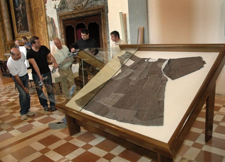 A file photo shows workers install a glass above the tunic of Saint Francis of Assisi during a exhibition in Gubbio
