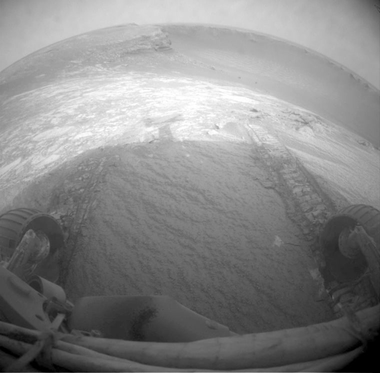 A wide-angle view taken by the Opportunity rover's front hazard-identification camera at the end of Tuesday's test drive shows the wheel tracks created by its short dip into Victoria Crater.