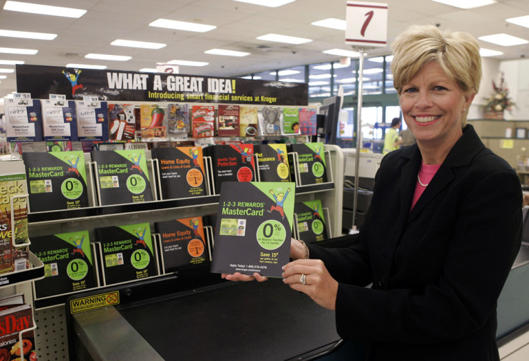 Kathy Kelly, president of Corporate Personal Finance for Kroger Co., displays a credit card brochure next to a display at a register in a Kroger grocery store in Union, Ky. 