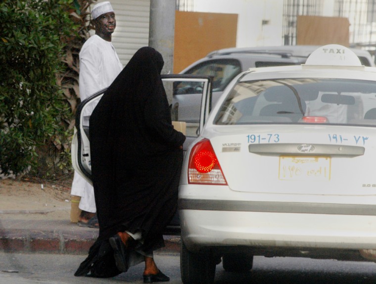 A woman gets in a taxi in Jiddah, Saudi Arabia, on Monday. The driving ban applies to all women, Saudi and foreign, and forces families to hire live-in drivers. 