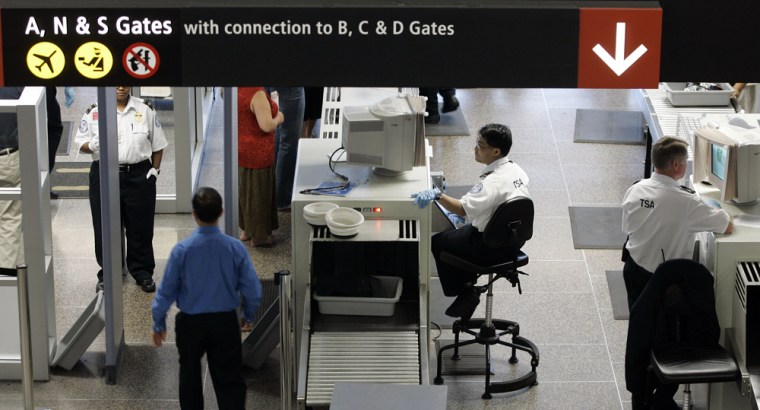 TSA workers screen passengers at Seattle-Tacoma International Airport in Seattle, Thursday, May 31, 2007. 
