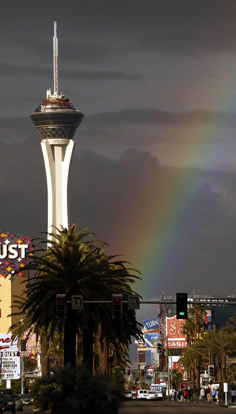 A rainbow illuminates the Stratosphere and the Las Vegas Boulevard 'strip'. Stay in Sin City on the cheap with an air/hotel package from United and Southwest Airlines, starting at $159.