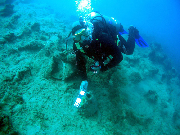 This image released George Robb of the Key West, Fla.-based RPM Nautical Foundation measuring an amphora during a month-long survey, the first step in compiling an underwater cultural heritage map that could eventually plot the position of sunken fleets believed to lie along Albania's coastline. 