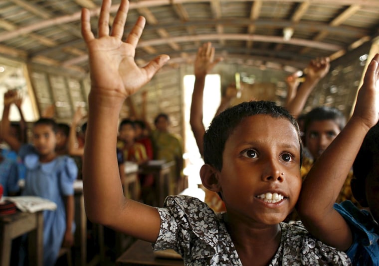 Bangladeshi village children attend a school at a boat