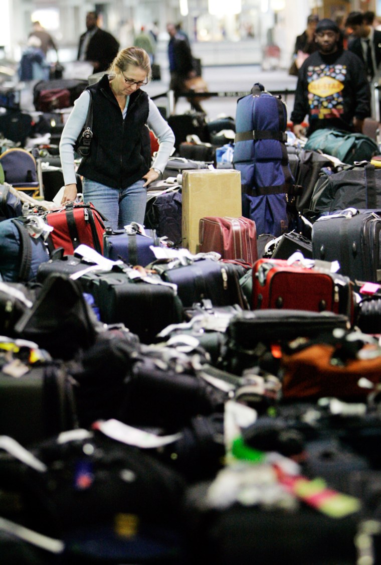 Carolann Manfredi, of Princeton, N.J., is seen searching through luggage at Philadelphia International Airport.